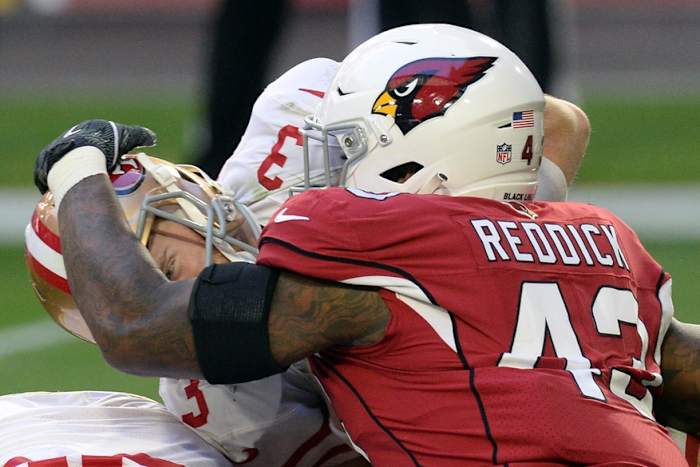 Arizona Cardinals outside linebacker Haason Reddick (43) grabs San Francisco 49ers quarterback C.J. Beathard (3) during the first half at State Farm Stadium.
